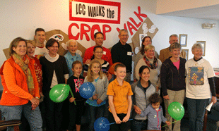 participants in Crop Walk gathered under wall banner